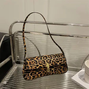 Chic leopard print shoulder bag with gold metal buckle and sleek rectangular design