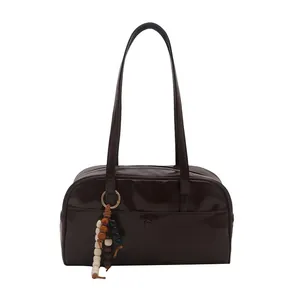 Deep brown faux leather pillow bag with long shoulder straps and wooden bead charm accessory