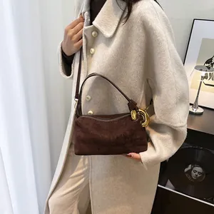 Vintage dark brown suede baguette bag with gold metal buckle on female model