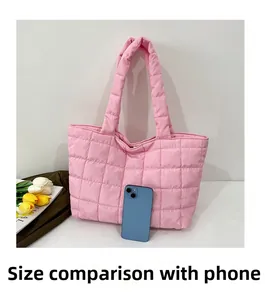 Pink quilted tote bag size comparison with a smartphone on a clean background