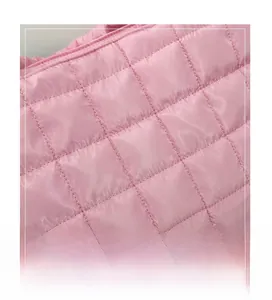 Close-up of soft pink quilted fabric with elegant diamond stitching for a tote bag