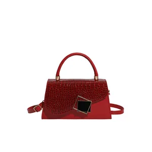 Borsa a tracolla rossa con trama a coccodrillo, manico rotondo e fibbia dorata