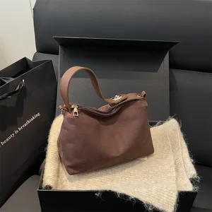 Vintage brown frosted suede handbag with golden hardware shown in premium gift box