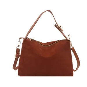Retro dark brown frosted suede shoulder bag with dual straps and sleek golden zippers