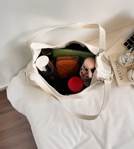 Macro shot showing the spacious interior of the beige tote bag with magnetic closure