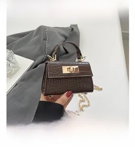 Close-up of a brown crocodile embossed mini bag with gold hardware and chain strap