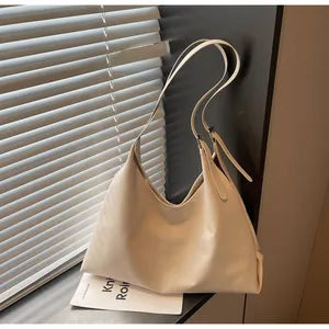Chic beige hobo tote bag with adjustable strap shown in aesthetic soft lighting