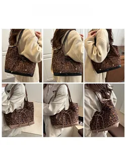 Detail view of leopard print tote bags in black and brown with bow ribbon accents