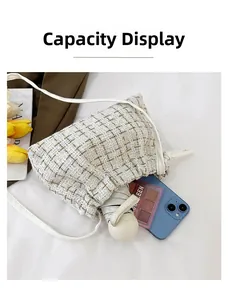 Capacity display showing tweed shoulder bag holding phone, cosmetics, and umbrella