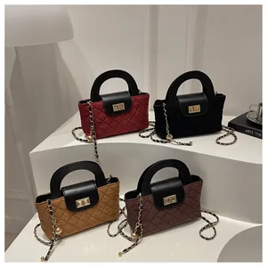 Detailed macro view of quilted texture bags with metallic gold chain and twist lock