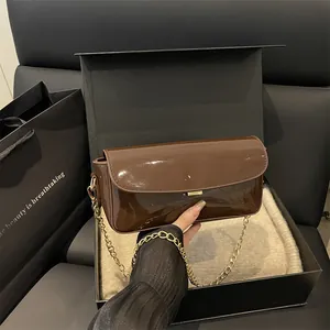 Dark brown patent leather rectangular shoulder bag with gold chain strap and metal buckle