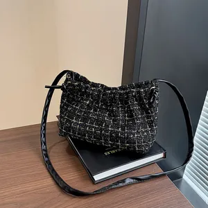 Fashionable black tweed underarm bag with gold metallic grid and cloud shape design