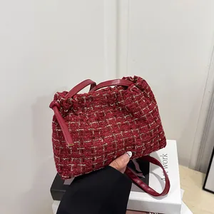 Deep red tweed shoulder bag with golden stitching and drawstring closure for women