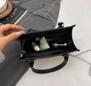 Macro shot showing large capacity of the black leather tote bag for essentials