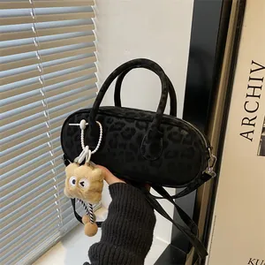 Chic black leopard print faux fur handbag with cute plush pendant and shoulder strap