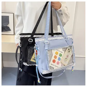 Detail of large tote bag featuring white lace trim and transparent PVC insert pocket