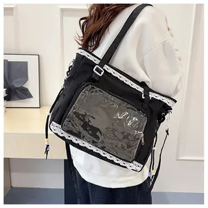 Detail of black ita bag with clear window, lace trim, and beads for Lolita style