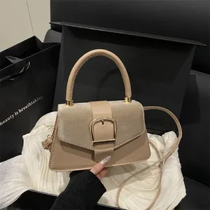 Minimalist beige crossbody bag with velvet flap and gold square buckle on satin