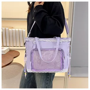 Detail of purple tote bag showing delicate white lace trim and adjustable shoulder strap