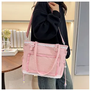 Pink tote bag with lace trim and transparent mesh pocket shown on a model