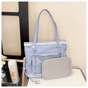 Detail of light purple tote itabag with white lace trim and transparent PVC display window