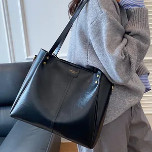 Classic black PU leather tote bag with gold hardware and logo for daily commute usage