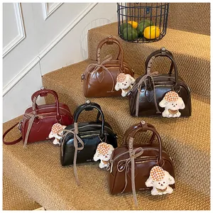 Detailed row of vintage pillow bags in five colors with cute puppy charms and ribbons