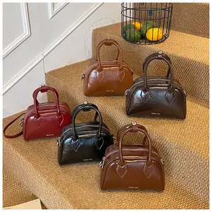 Detail showing high-shine leather vintage bowling bags in multiple retro autumn colors