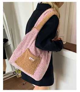 Detail of pink leopard plush tote bag with brown faux fur pocket and cherry logo tag