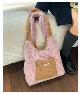Detail of plush leopard print tote bag with brown teddy fleece pocket and label