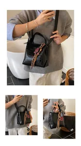 Detailed views of a black crocodile-pattern bucket bag with a cute bear charm accessory