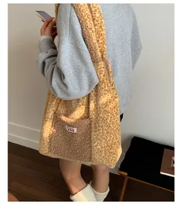 Model wearing a leopard print plush tote bag with a brown teddy fleece front pocket