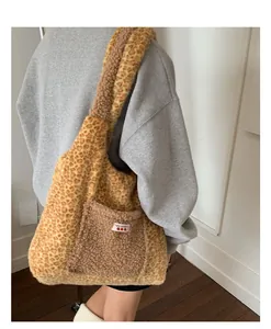 Detailed view of plush leopard print tote bag with brown pocket and YES HONEY woven label