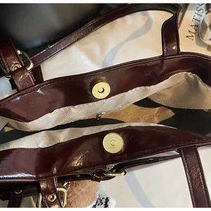Détail du cabas en cuir ciré bordeaux avec fermeture magnétique et doublure à chevrons