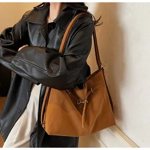 Detailed view of caramel brown tote bag with metal buckle and premium leather texture
