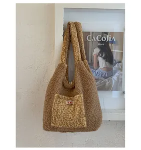 Detail of plush tote bag showing leopard print pocket with Yes Honey label and soft texture