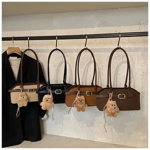 Row of retro faux leather shoulder bags in beige, black, and brown with cute bear charms