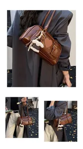 Detail of vintage brown leather handbag with heart tag and plush dog charm accessory