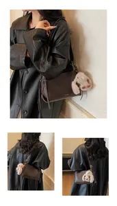 Detail of a vintage dark brown leather shoulder bag with a cute plush rabbit charm