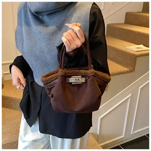 Detailed view of dark brown suede bucket bag with soft shearling trim and silver lock