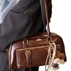 Brown patent leather shoulder bag with vintage pillow design and cute dog pendant