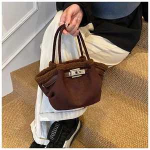 Detail of dark brown faux fur trim and suede texture on a stylish women bucket bag