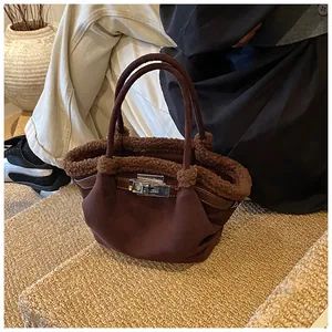 Detailed view of dark brown bucket bag with plush trim and silver metallic turn-lock closure