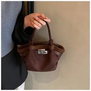 Detail of coffee brown faux suede bucket bag with soft teddy fur trim and silver metal lock