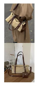 Dettaglio borsa tote in pelle scamosciata kaki con cinturini marroni e mini pochette