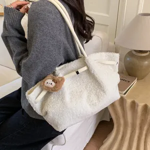 White fuzzy fleece tote bag for women with leather straps and bear charm in cozy room