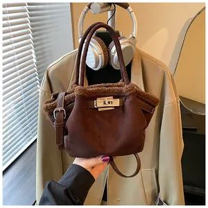 Detail of dark coffee suede bucket bag featuring brown faux fur trim and silver metal twist lock