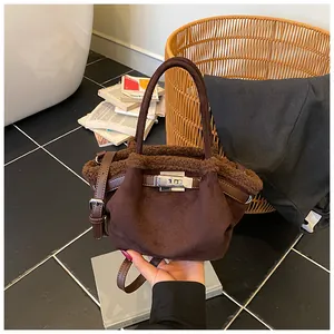 Detail of vintage brown suede bucket bag with faux fur trim and silver turn-lock closure