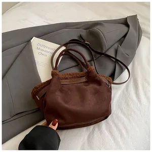 Detail view of the brown suede bucket bag with plush faux fur trim for autumn winter