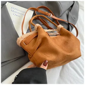 Detail of brown faux suede bucket bag with beige fleece trim and silver turn-lock closure